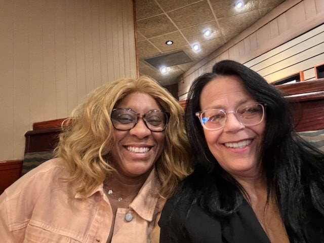 LaDonna Claude smiling with colleague at event