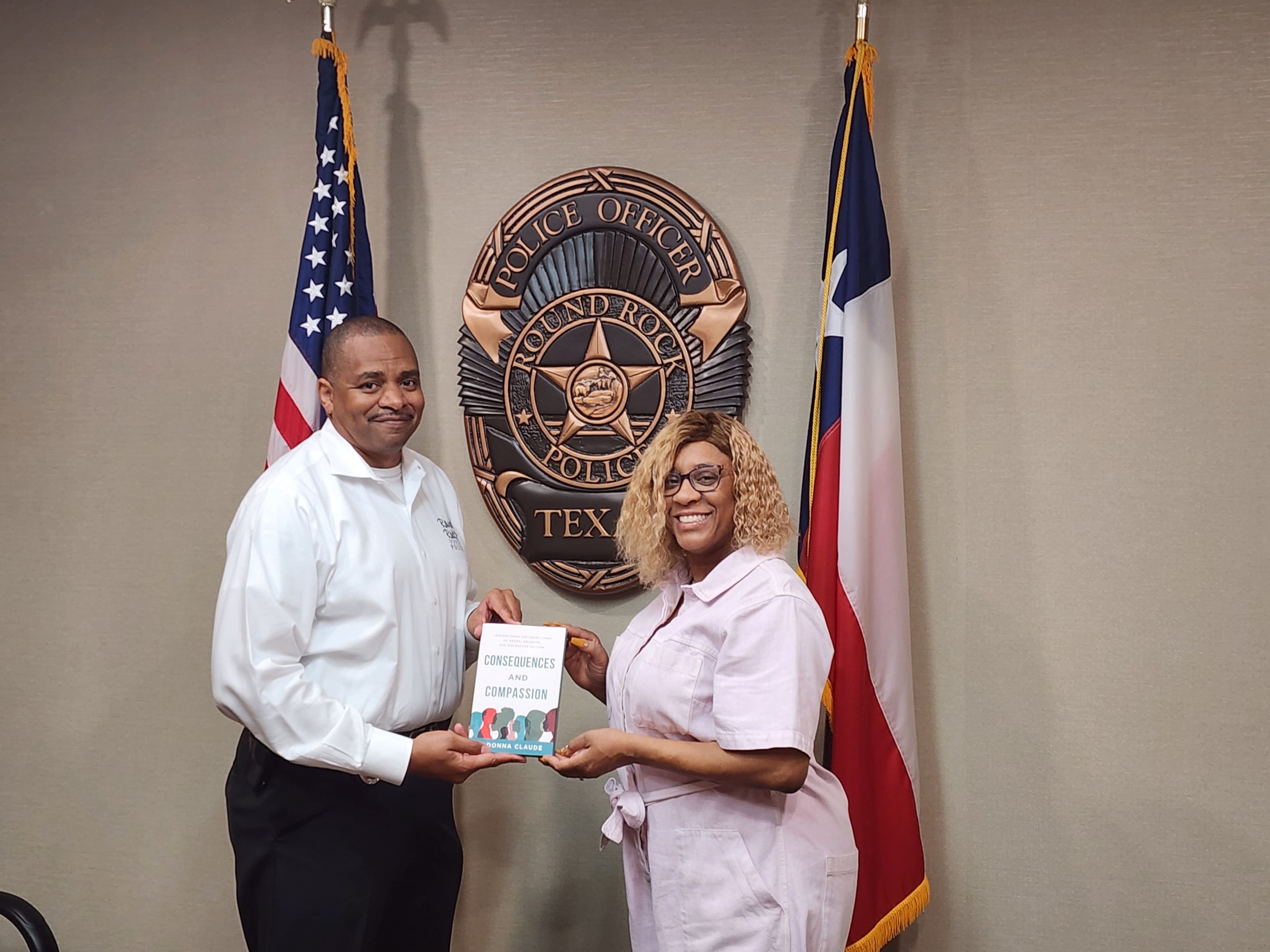 LaDonna Claude with Round Rock Police officer holding Consequences and Compassion