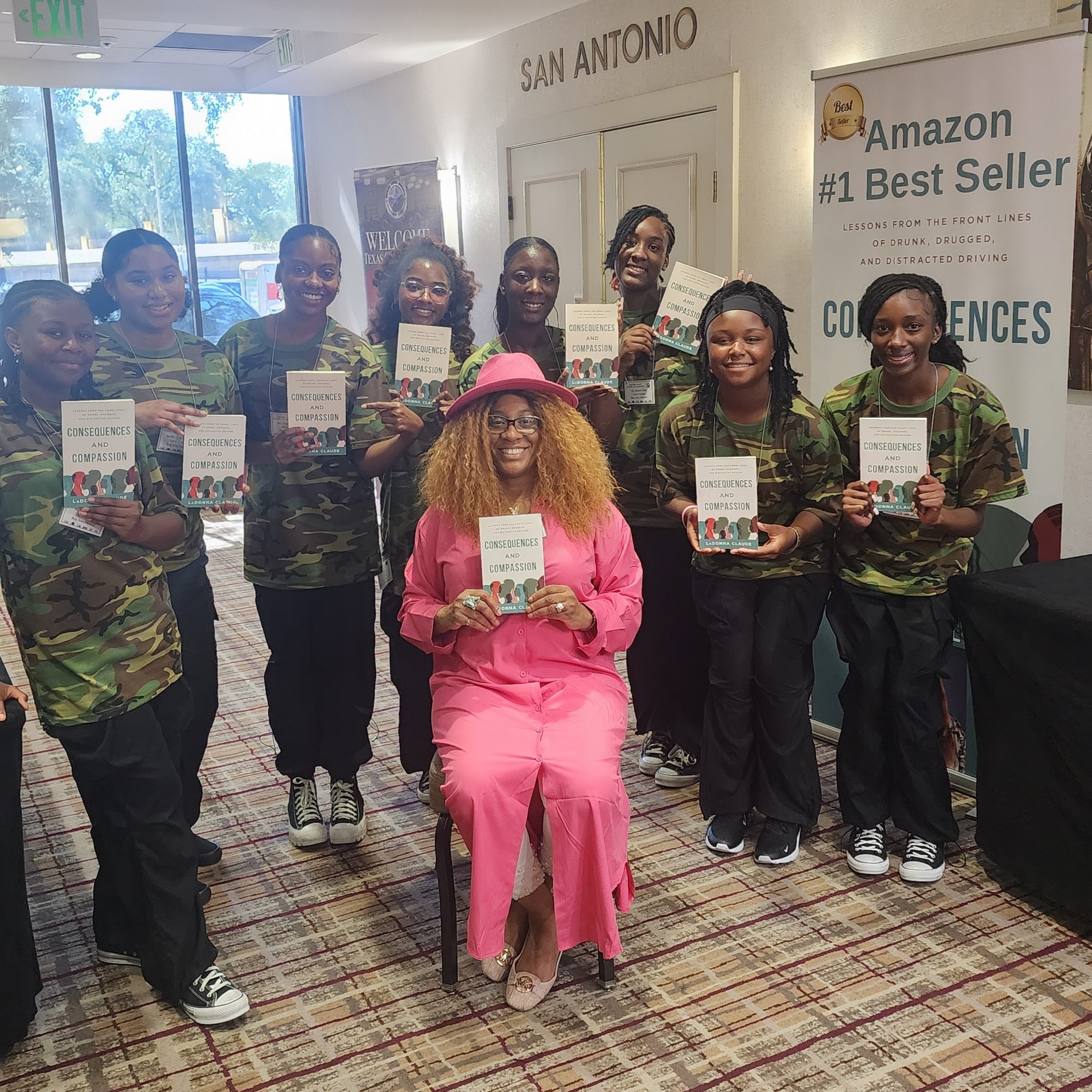 LaDonna Claude with JROTC cadets holding Consequences and Compassion at San Antonio Amazon #1 Bestseller event
